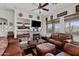 Comfortable living room with leather furniture, built-in shelving, a fireplace, and beautiful views at 9722 S 45Th Ave, Laveen, AZ 85339