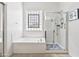 Main bathroom featuring a tub and glass-enclosed shower at 9722 S 45Th Ave, Laveen, AZ 85339
