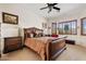 View of a bedroom with a large wooden sleigh bed, dresser, and natural light at 9722 S 45Th Ave, Laveen, AZ 85339