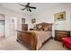 View of a bedroom with a large wooden sleigh bed and a matching dresser on each side at 9722 S 45Th Ave, Laveen, AZ 85339