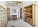 A functional home office featuring built-in bookshelves, a desk, and neutral colored carpet at 9722 S 45Th Ave, Laveen, AZ 85339