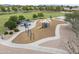 Aerial view of a community playground with slides, swings, and shaded seating in a grassy, landscaped area at 9722 S 45Th Ave, Laveen, AZ 85339