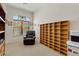 Versatile room with a leather chair, built-in shelving, and a stained glass window at 9722 S 45Th Ave, Laveen, AZ 85339