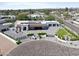 Stunning aerial view of the custom home with a tiled roof, solar panels and a large private driveway at 10024 N 61St Pl, Paradise Valley, AZ 85253