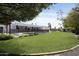 Sprawling backyard with lush lawn, pool with fence, and modern architecture at 10024 N 61St Pl, Paradise Valley, AZ 85253