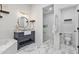 Bathroom featuring double sink vanity, soaking tub, and walk-in shower with white tiling at 10024 N 61St Pl, Paradise Valley, AZ 85253