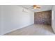 Minimalist bedroom with brick wall and orange ceiling fan at 10024 N 61St Pl, Paradise Valley, AZ 85253