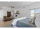 Open bedroom and living area showing a fireplace and barn door to bathroom at 10024 N 61St Pl, Paradise Valley, AZ 85253