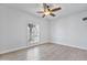 Empty bedroom with neutral walls, wood floors and a window covered with shutters at 10024 N 61St Pl, Paradise Valley, AZ 85253