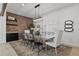 Elegant dining room with exposed brick, modern lighting, and seating for eight at 10024 N 61St Pl, Paradise Valley, AZ 85253