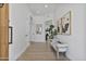 Bright foyer with wood-look tile flooring, white walls, and a stylish bench at 10024 N 61St Pl, Paradise Valley, AZ 85253