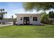 Detached structure with double doors, windows, and green lawn at 10024 N 61St Pl, Paradise Valley, AZ 85253