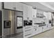 This kitchen showcases stainless steel appliances, elegant white cabinets, and a modern backsplash at 10024 N 61St Pl, Paradise Valley, AZ 85253