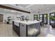 Open kitchen featuring a large island with seating, stainless steel appliances, and open floor plan at 10024 N 61St Pl, Paradise Valley, AZ 85253