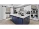 Modern kitchen with a large island, white cabinets, stainless steel appliances, and a pantry at 10024 N 61St Pl, Paradise Valley, AZ 85253