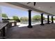 Covered outdoor kitchen and patio overlooking a sparkling pool with safety fence at 10024 N 61St Pl, Paradise Valley, AZ 85253