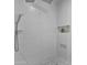 Walk-in shower featuring white tiled walls and a built-in shelf at 10024 N 61St Pl, Paradise Valley, AZ 85253