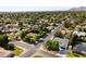 Aerial view of a residential neighborhood featuring mature trees and well-maintained homes at 1018 W State Ave, Phoenix, AZ 85012