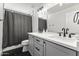 Bathroom featuring a dual sink vanity with shower and tub combination at 1018 W State Ave, Phoenix, AZ 85012