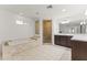 Bright bathroom featuring a soaking tub, glass shower, and double sink vanity at 1018 W State Ave, Phoenix, AZ 85012