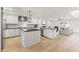 Bright, open kitchen with a large center island, stainless steel appliances, and hardwood floors at 1018 W State Ave, Phoenix, AZ 85012