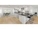 Open kitchen featuring stainless appliances, a center island with bar stool seating, and hardwood floors at 1018 W State Ave, Phoenix, AZ 85012