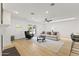 Bright and spacious living room with hardwood floors, a ceiling fan, and access to the backyard at 1018 W State Ave, Phoenix, AZ 85012