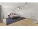Spacious main bedroom featuring wood floors, fan, recessed lighting, and contemporary decor at 1018 W State Ave, Phoenix, AZ 85012