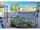 Backyard with a privacy wall, a covered patio, a table and chairs, and a raised garden at 10225 W Camelback Rd # 45, Phoenix, AZ 85037
