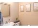 Charming powder room features a decorative mirror, delicate floral prints, and fresh soap at 10225 W Camelback Rd # 45, Phoenix, AZ 85037