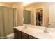 Bathroom featuring double sinks and a neutral-toned shower curtain for a clean and functional space at 10225 W Camelback Rd # 45, Phoenix, AZ 85037