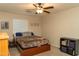 Bedroom featuring a ceiling fan and plush bedding, offering a comfortable and relaxing space at 10225 W Camelback Rd # 45, Phoenix, AZ 85037