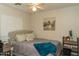 Cozy bedroom with a decorative headboard and ceiling fan, creating a relaxing atmosphere at 10225 W Camelback Rd # 45, Phoenix, AZ 85037