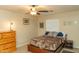 Neutral bedroom featuring a ceiling fan, framed artwork, and a warm, inviting atmosphere at 10225 W Camelback Rd # 45, Phoenix, AZ 85037