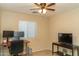 Bedroom featuring a ceiling fan and a home office, ideal for work or leisure at 10225 W Camelback Rd # 45, Phoenix, AZ 85037