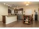 Open kitchen features stainless steel appliances, tile flooring and an eat-in dining area at 10225 W Camelback Rd # 45, Phoenix, AZ 85037