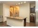A kitchen island is featured, complete with stainless steel sink and tile flooring at 10225 W Camelback Rd # 45, Phoenix, AZ 85037