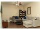 Bright living room with a ceiling fan, gray sectional sofa, and modern furnishings at 10225 W Camelback Rd # 45, Phoenix, AZ 85037