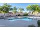 Community pool surrounded by green trees and landscaping offers a refreshing retreat at 10225 W Camelback Rd # 45, Phoenix, AZ 85037
