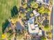 Aerial view of home featuring a custom pool, surrounding greenery, desert landscape and private community at 10664 E Monument Dr, Scottsdale, AZ 85262
