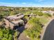 Stunning home with desert landscaping, mature trees, brick driveway, and an attached two-car garage at 10664 E Monument Dr, Scottsdale, AZ 85262