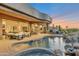 Resort-style backyard featuring a custom pool, spa, and covered patio with ample seating and desert views at 10664 E Monument Dr, Scottsdale, AZ 85262