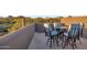 Outdoor balcony featuring four person seating with picturesque view of the golf course and mountains at 10664 E Monument Dr, Scottsdale, AZ 85262