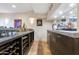 Basement bar with countertop seating, custom cabinets and display cases for collectibles and beverages at 10664 E Monument Dr, Scottsdale, AZ 85262