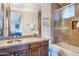 Beautiful bathroom featuring granite countertop, wood cabinets and a glass shower with tan stone backsplash at 10664 E Monument Dr, Scottsdale, AZ 85262