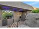 Desert home with a covered entryway featuring unique architecture and natural rock formations at 10664 E Monument Dr, Scottsdale, AZ 85262
