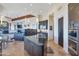Open kitchen with an island, dark cabinetry, and stainless steel appliances, connecting seamlessly to the living area at 10664 E Monument Dr, Scottsdale, AZ 85262