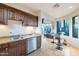 Kitchenette featuring wood cabinets, granite countertops, and stainless steel appliances at 10664 E Monument Dr, Scottsdale, AZ 85262