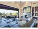 Modern living room with a corner fireplace, comfortable seating, and a sliding glass doors leading to a patio at 10664 E Monument Dr, Scottsdale, AZ 85262