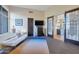 Spacious living room with decorative glass doors, modern furniture, and ample natural light at 10664 E Monument Dr, Scottsdale, AZ 85262